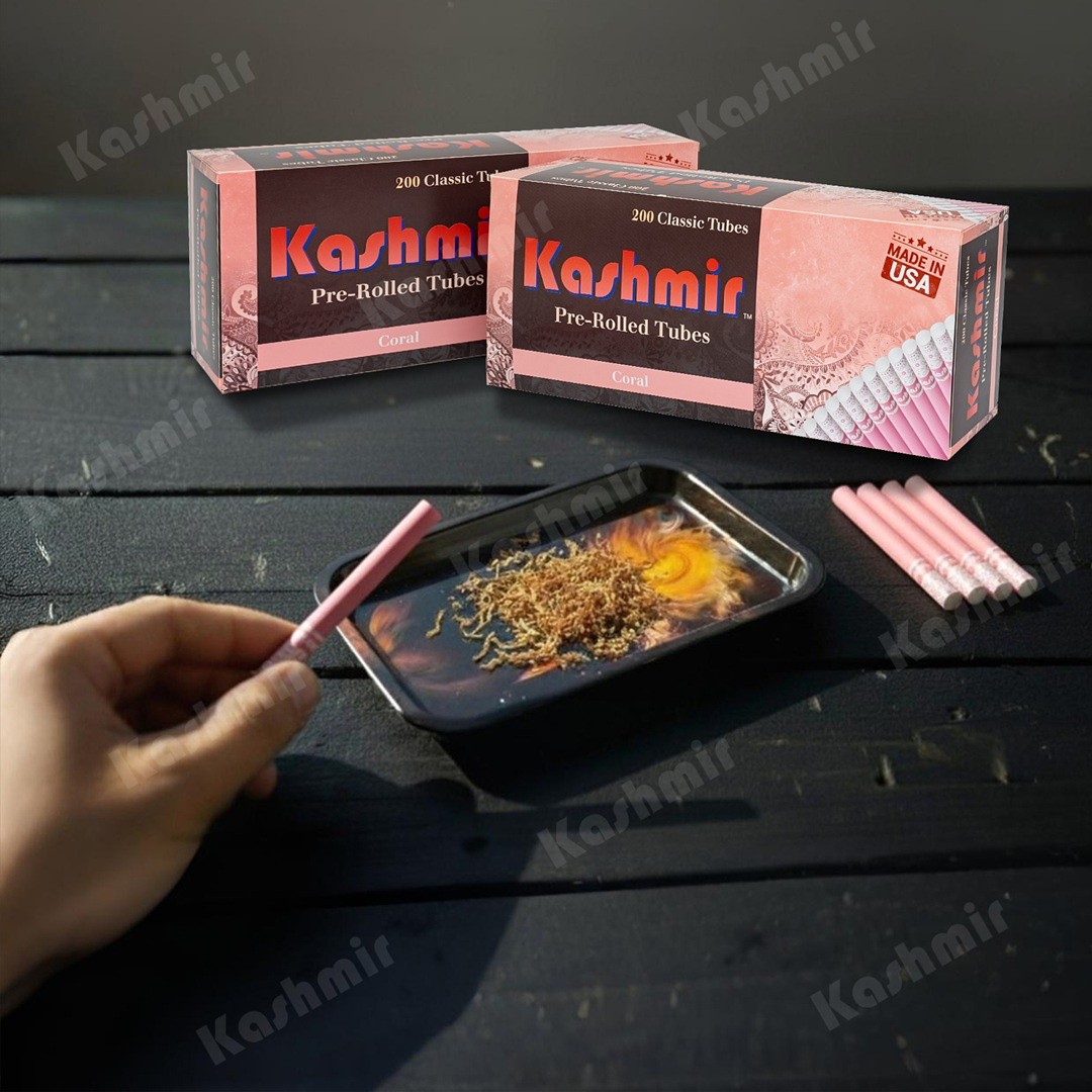 Two cartons of Kashmir Coral colored cigarette tubes, 200-count each, with a hand filling a pink tube over a tray of loose tobacco; Made in USA badge visible.