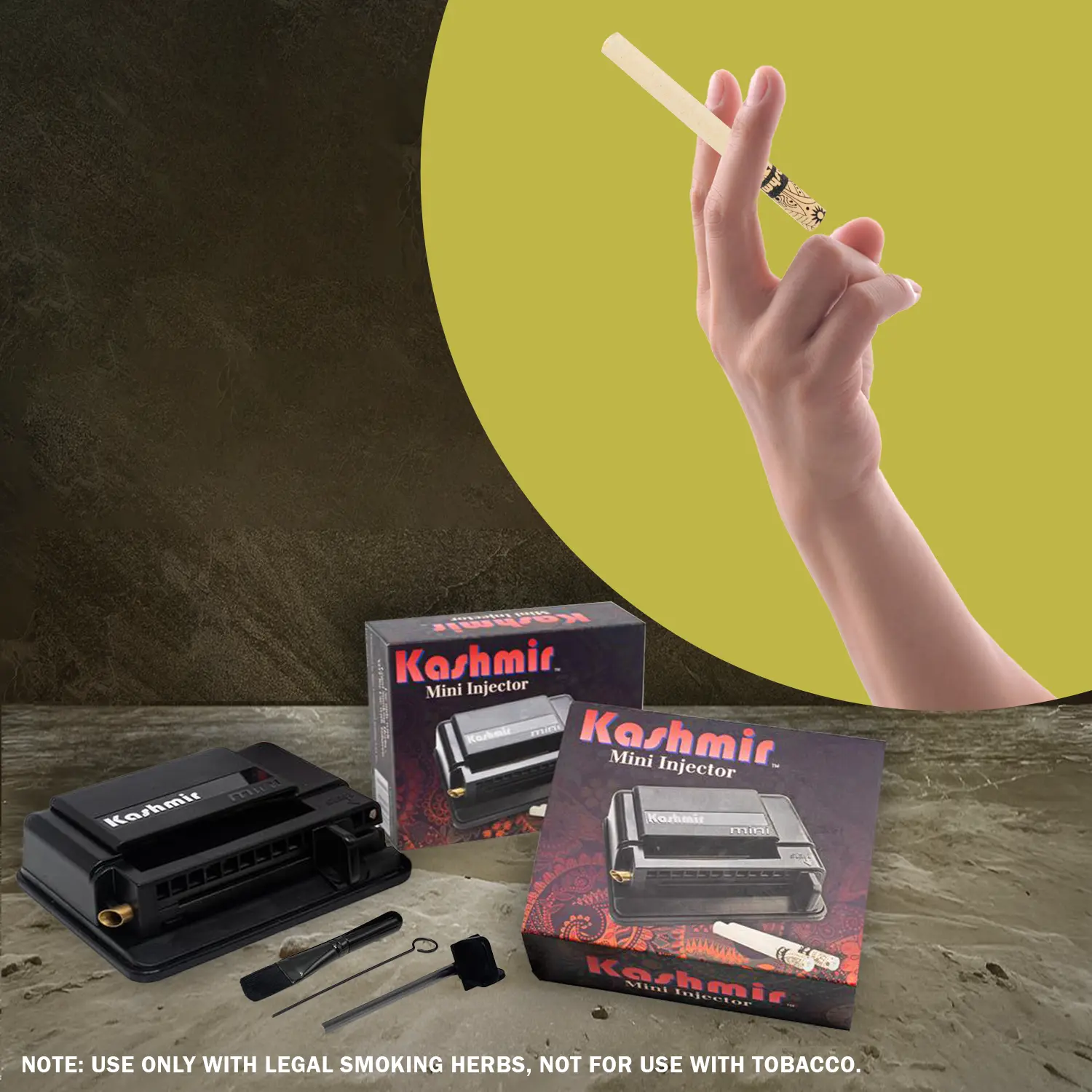 Hand holding a Kashmir Cigarette Tube above a Kashmir Mini Injector with boxes and its tool kit on a stone surface.