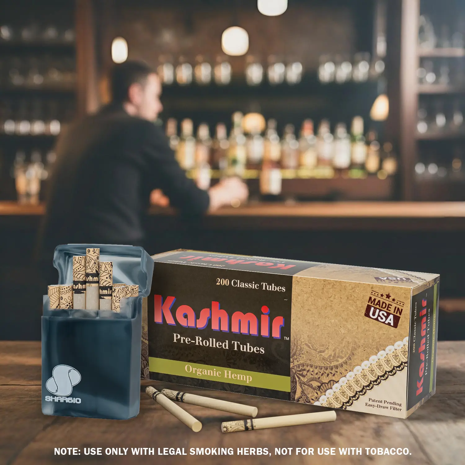 Kashmir 100% Organic Hemp Pre Rolled Cigarette Tubes 200ct carton with travel case and loose Kashmir Hemp Tubes on a bar counter; Made in USA; Deliver across USA.