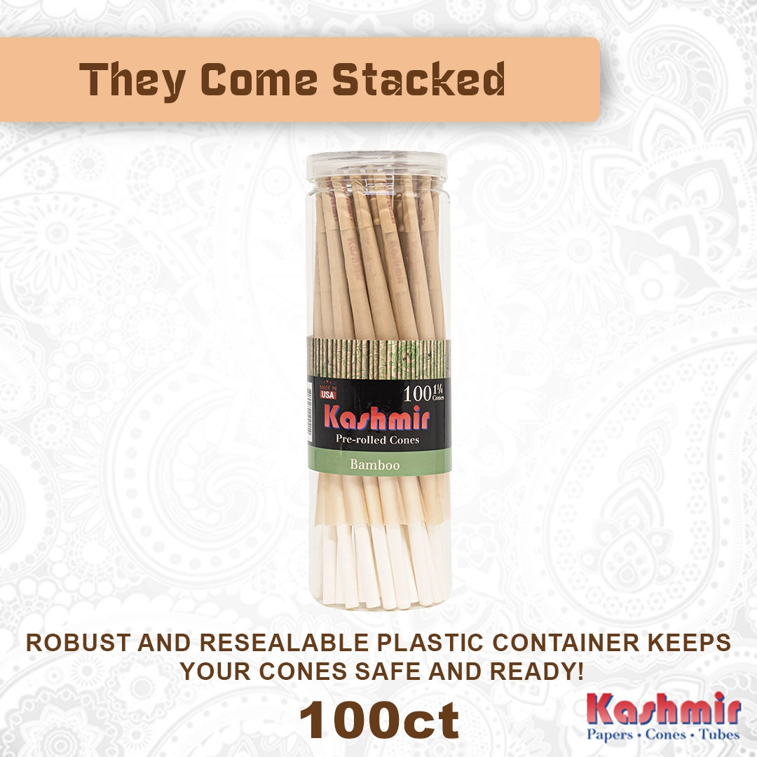Kashmir 1 1/4 Bamboo Cones, 100 count jar with “They Come Stacked” banner showing natural bamboo pre-rolled cones with W-filters in a resealable plastic container, made in the USA.
